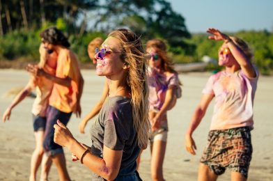 multinational multicultural mixed race friends in holi dust on beach in Goa